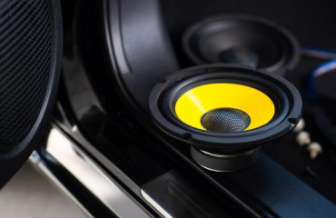 Yellow subwoofer speaker in car audio system 