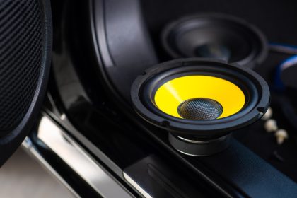 Yellow subwoofer speaker in car audio system 