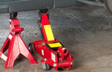 floor jack with jack stand under vehicle