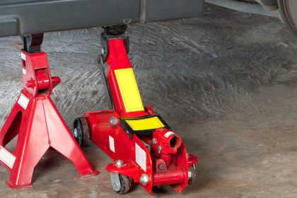 floor jack with jack stand under vehicle