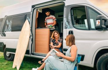 People hanging out with camper van