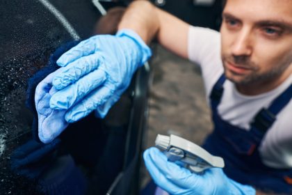 cleaning car in garage with degreaser