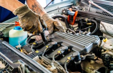 Person working on the engine of a car