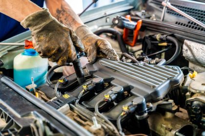 Person working on the engine of a car