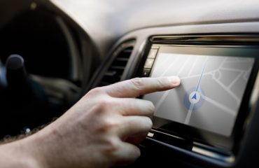 Person using car stereo touchscreen