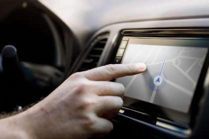 Person using car stereo touchscreen