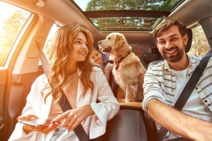 family driving with dog