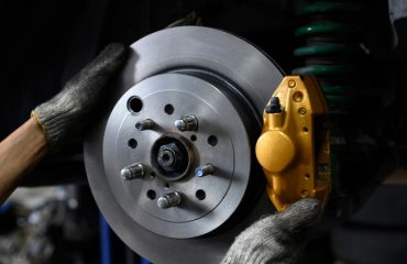 Mechanic installing brake calipers