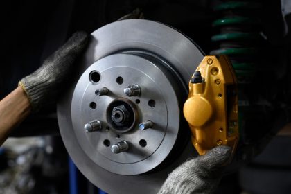 Mechanic installing brake calipers