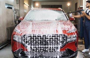 Man cleaning car with foam cannon