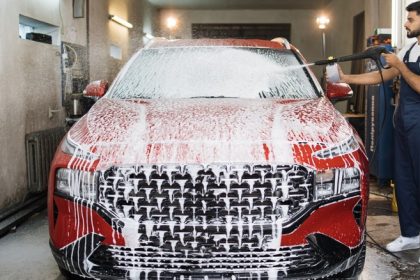 Man cleaning car with foam cannon