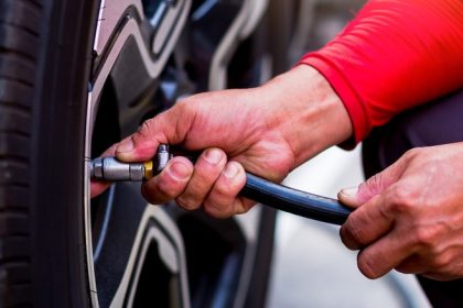 Person filling tire with air