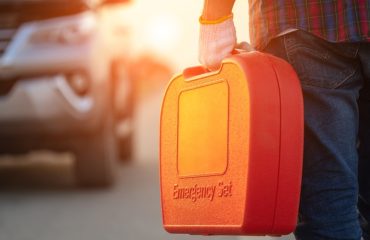 person with orange emergency set walking toward truck