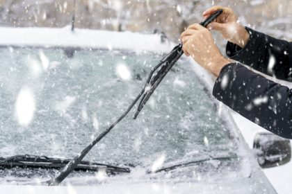 person inspecting wiper blades winter