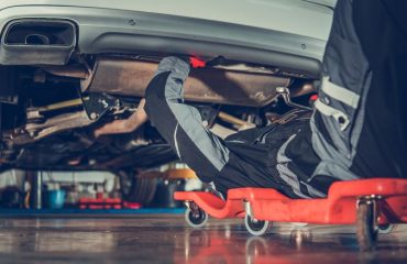 mechanic working on car undercarriage