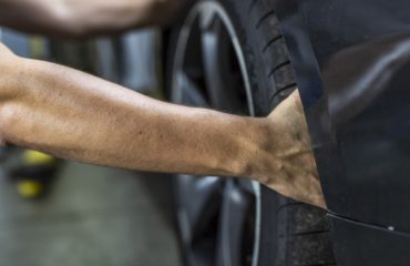 person grabbing tire