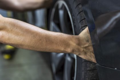 person grabbing tire