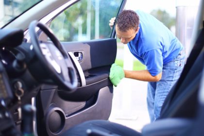 A Man Cleaning The Inside Of A Car