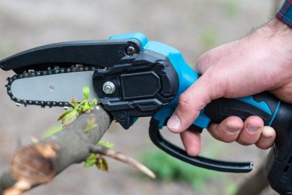 Small handheld chainsaw in use