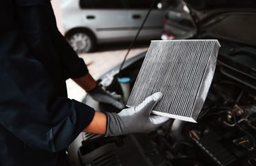 Mechanic holding a dirty air filter