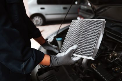 Mechanic holding a dirty air filter