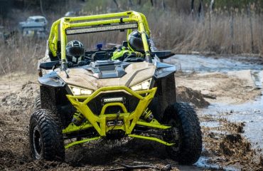 Polaris UTV driving through mud