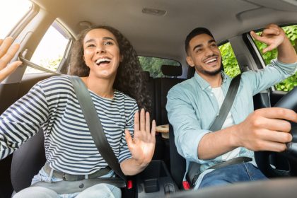 Driver and passenger listening to music