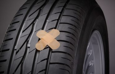 Tire with cross-shaped patch